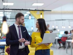 A man and woman communicate in a cross cultural work environment